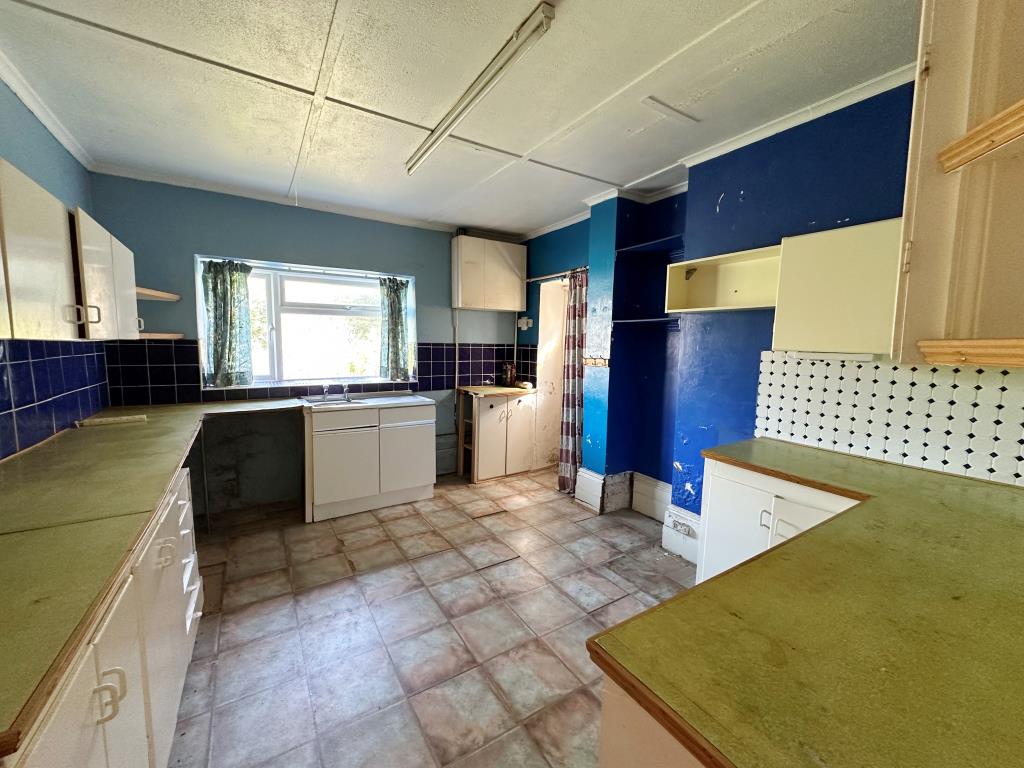 Lot: 129 - EIGHT-BEDROOM SEMI-DETACHED HOUSE FOR REFURBISHMENT - Kitchen with access into garden